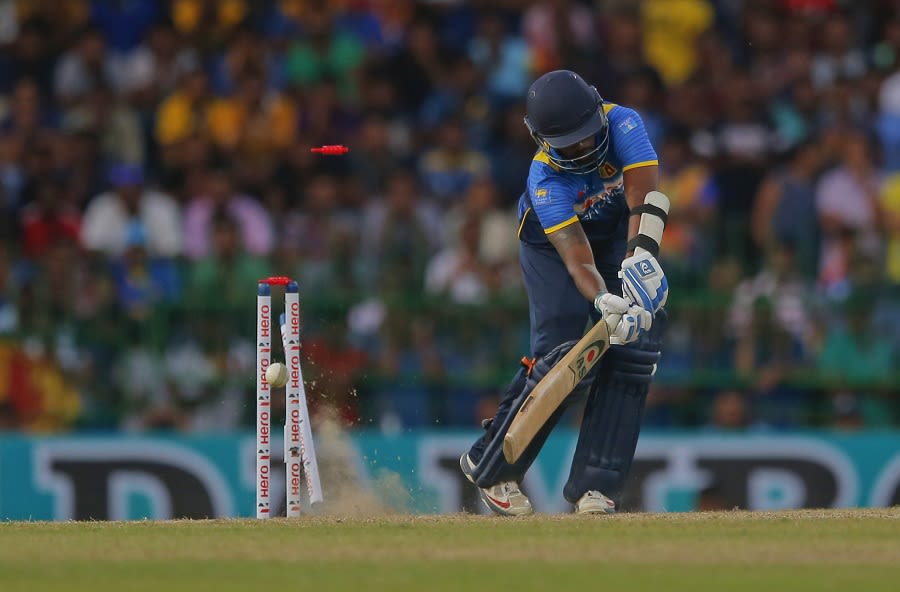 Amila Aponso is bowled by Mitchell Starc