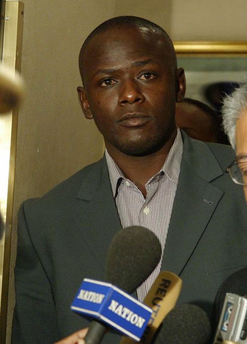 Maurice Odumbe and his lawyer in court
