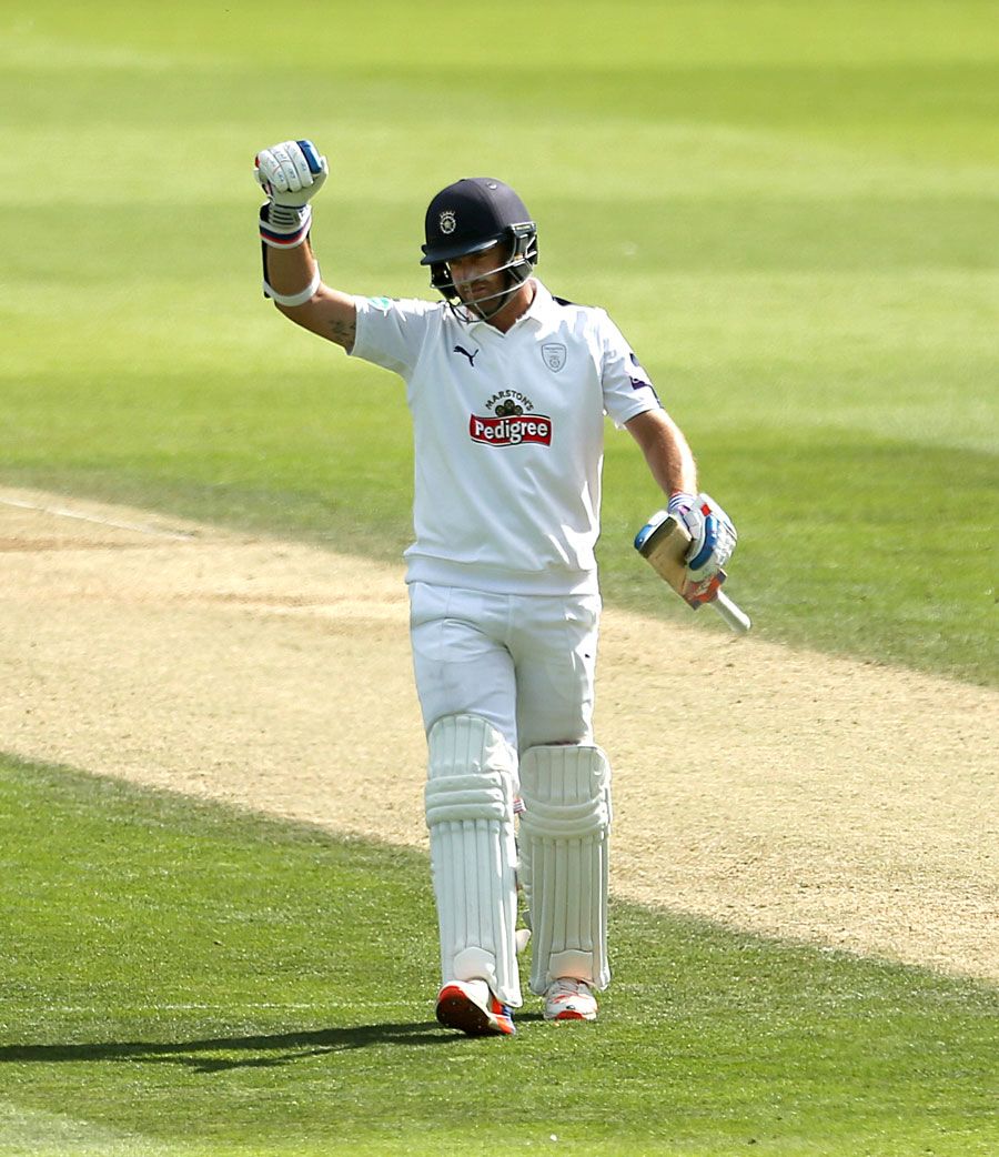Sean Ervine punches the air after reaching his century