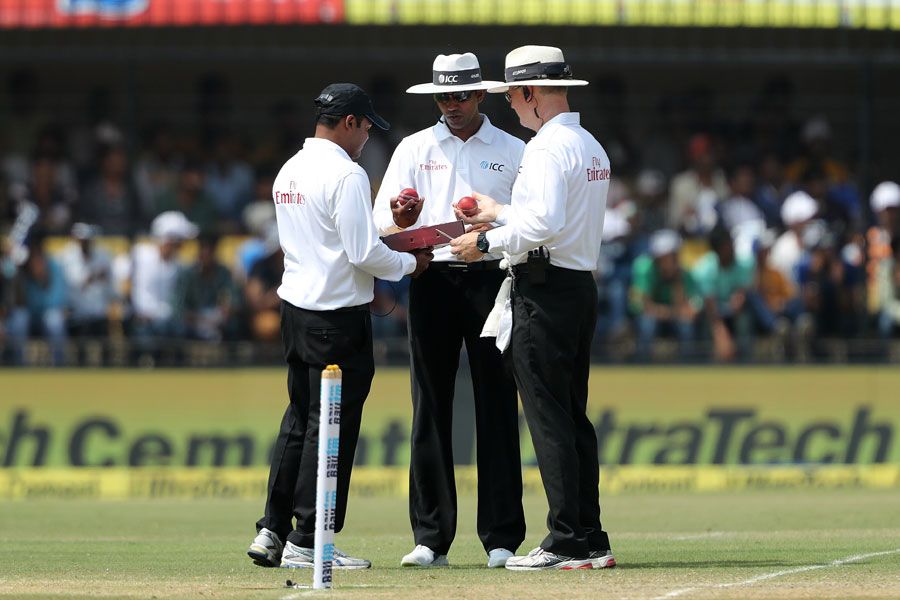 Umpires C Shamshuddin, Kumar Dharmasena and Bruce Oxenford pick a ball