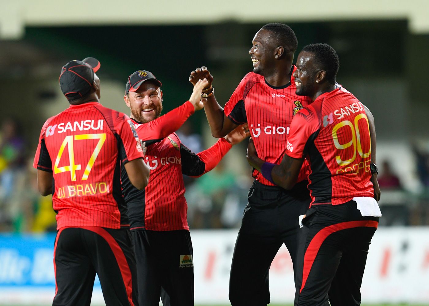 Dwayne Bravo, Brendon McCullum, Kevon Cooper and Sulieman Benn celebrate a wicket