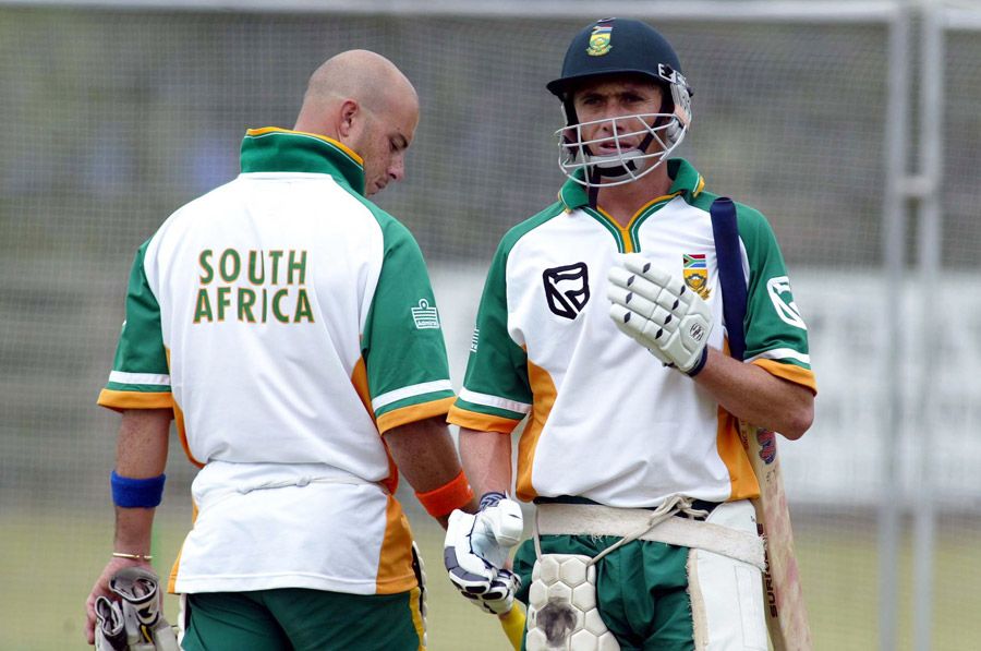 Alan Dawson walks past Herschelle Gibbs in training
