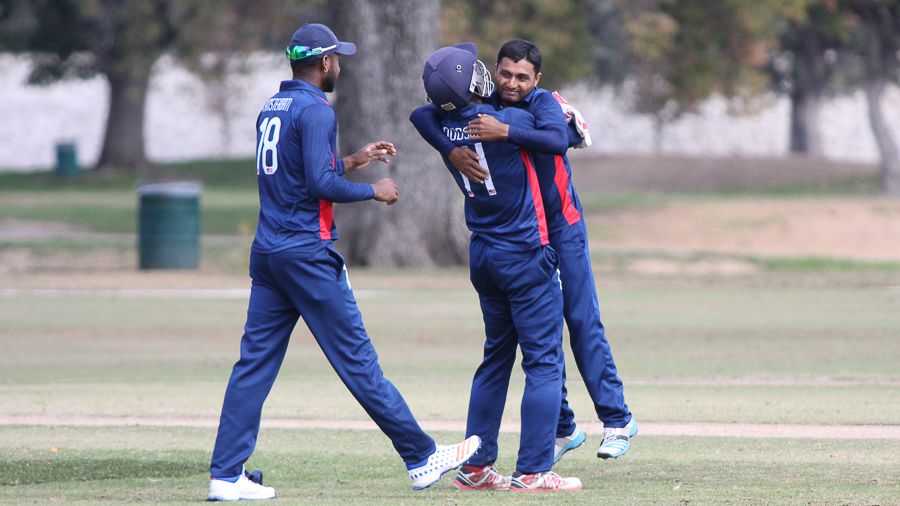 Timil Patel gets hugged by Akeem Dodson after taking a five-for