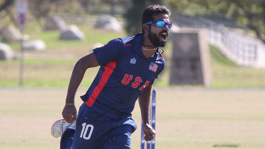 Prashanth Nair runs off to high-five Nicholas Standford after taking the wicket of Nat Watkins