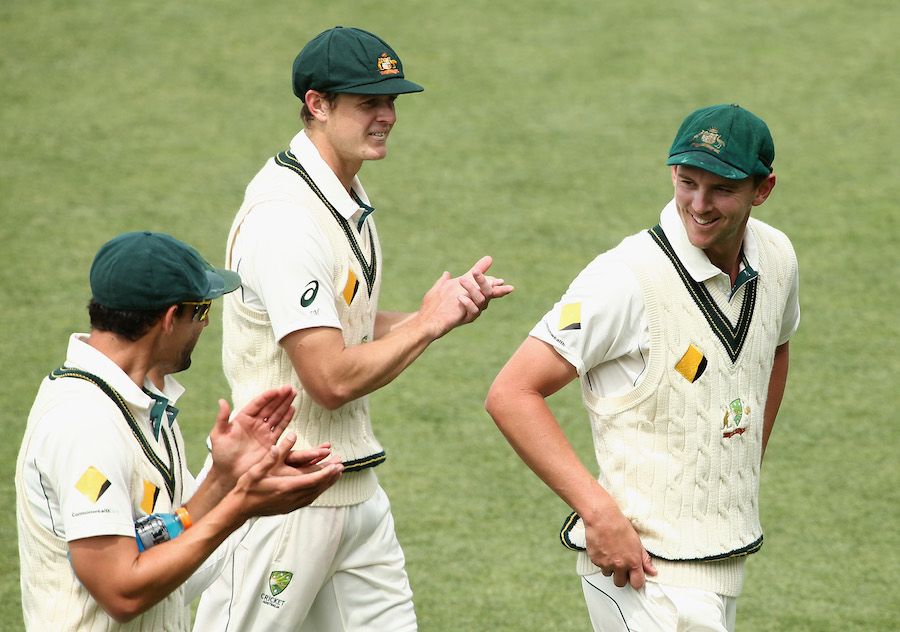 Mitchell Starc and Joe Mennie applaud Josh Hazlewood off the field