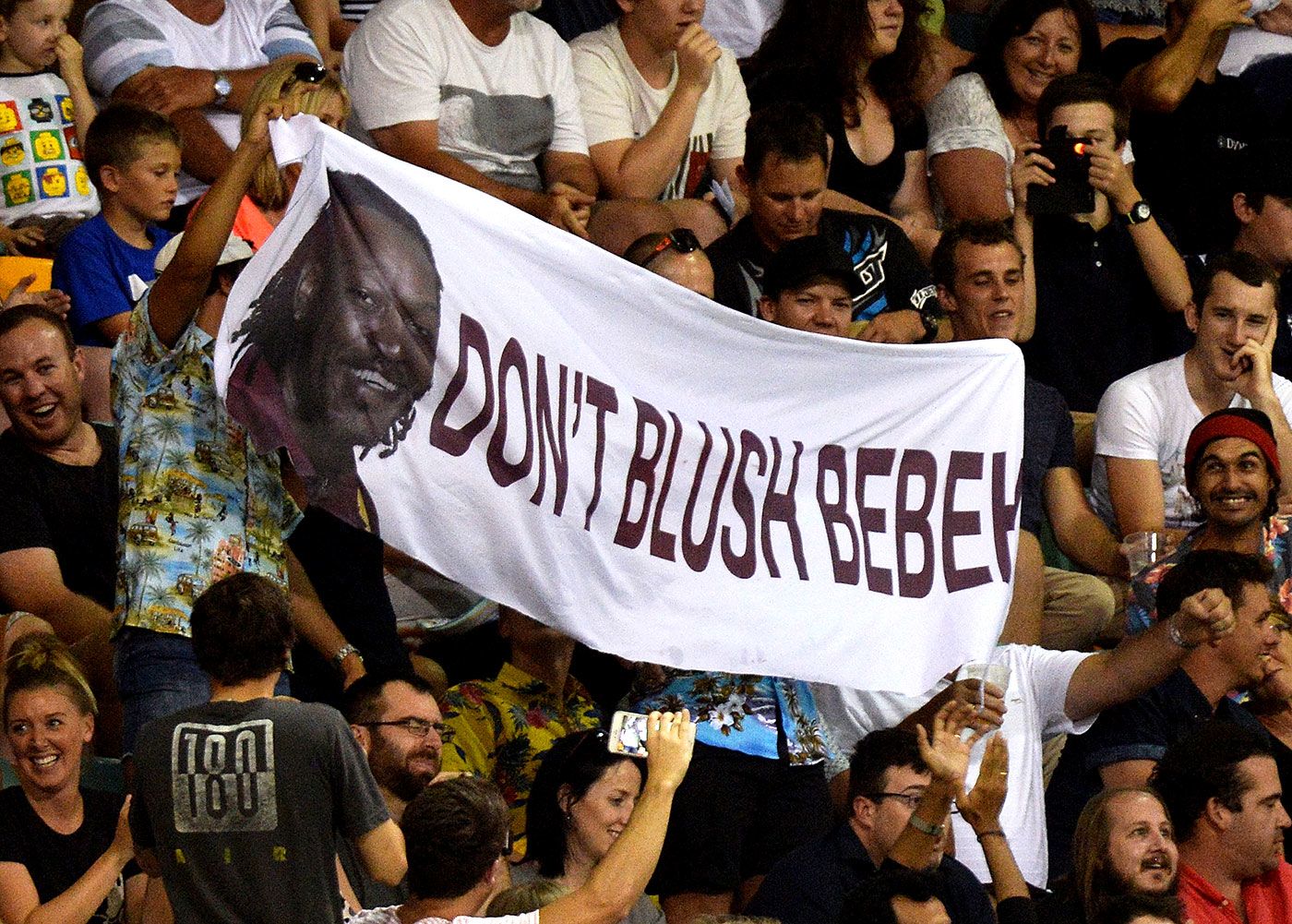 Spectators hold up a banner referring to Chris Gayle's comments to a female sports presenter