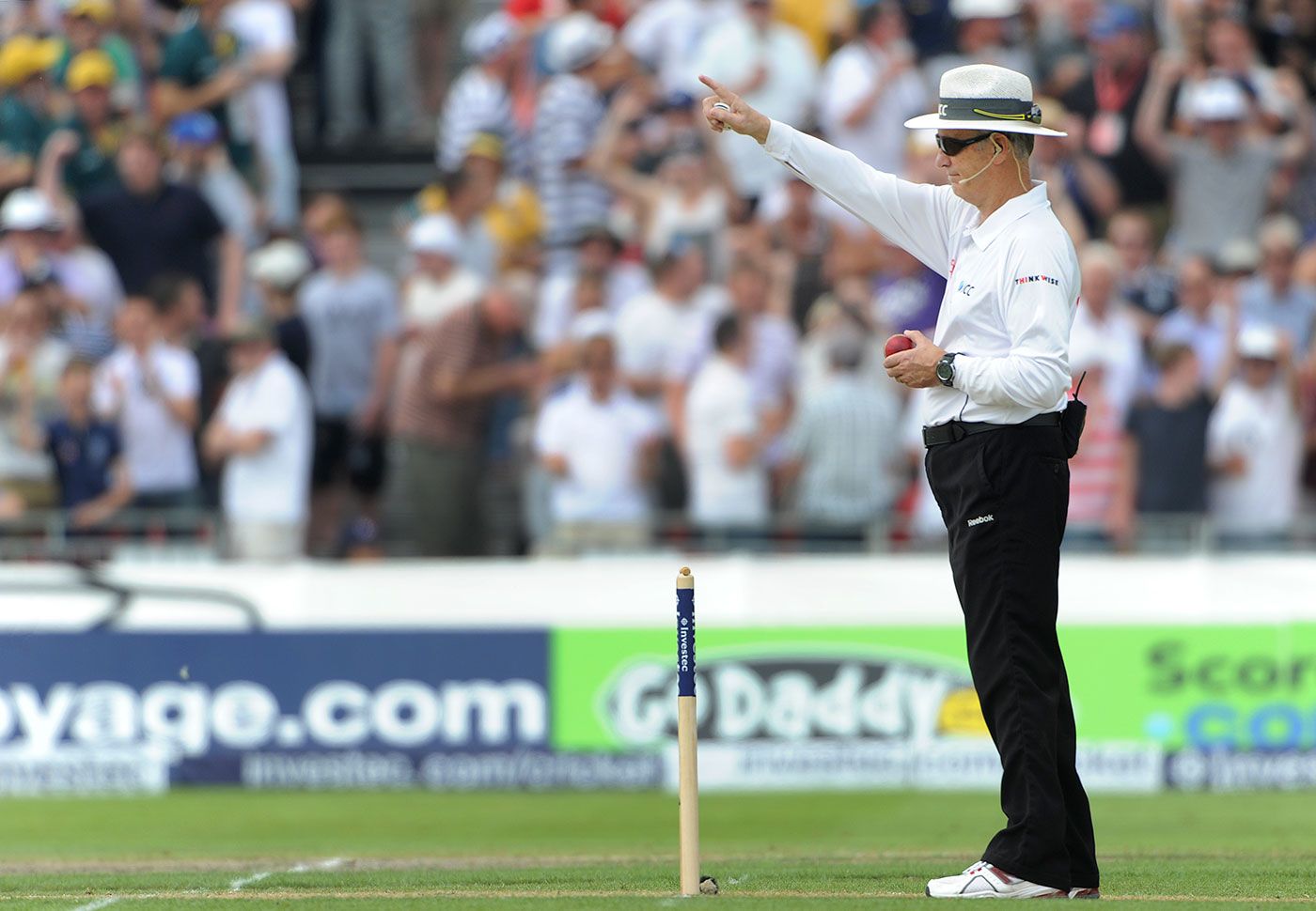 Umpire Tony Hill raises his finger