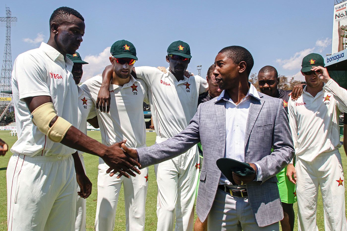 Fast bowler Carl Mumba receives his Zimbabwe Test cap from former captain Tatenda Taibu