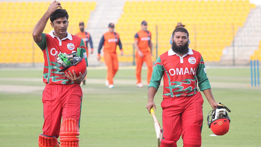 Naseem Khushi (l) and Khurram Nawaz (r) walk off after their 57-run stand