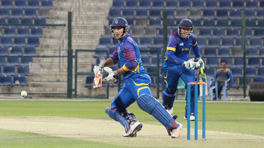 JP Kotze completes a reverse sweep to medium pacer Amjad Javed on his way to a half-century