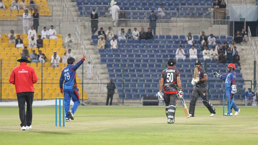Rashid Khan points Muhammad Usman back to the pavilion after bowling him behind his legs