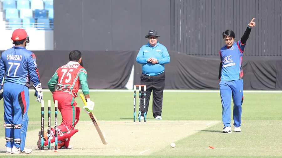 Rashid Khan points Khurram Khan back to the dugout after bowling him for 24