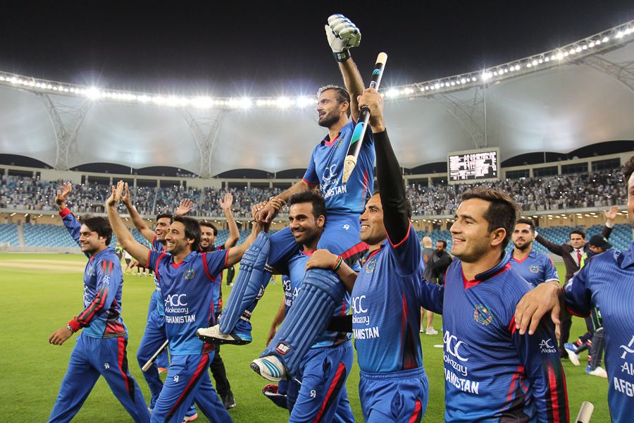 Team-mates carry Nawroz Mangal on a victory lap