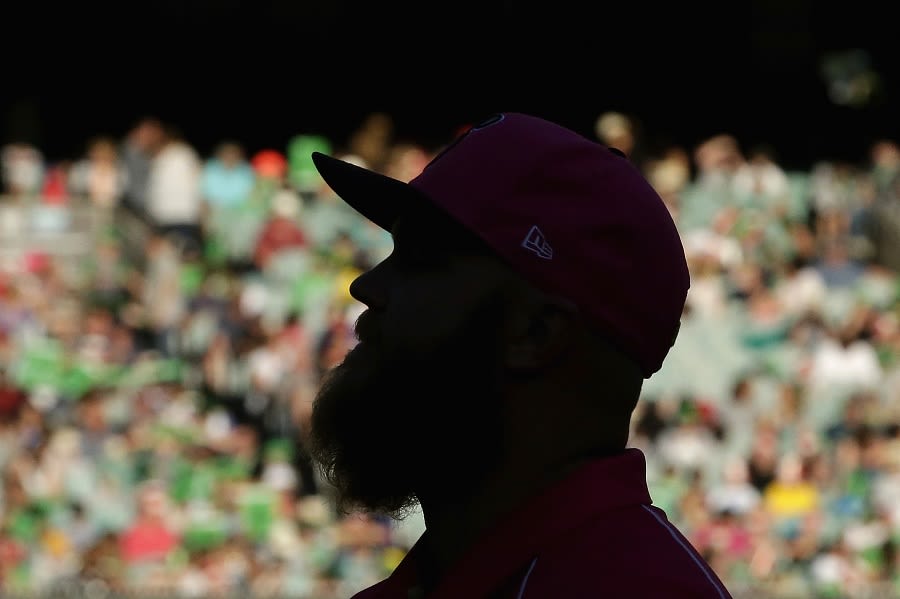 Doug Bollinger is silhouetted against the MCG crowd