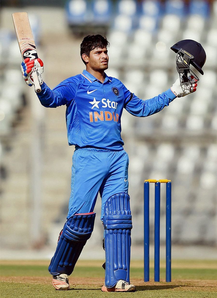 Himanshu Rana raises his bat after reaching a century