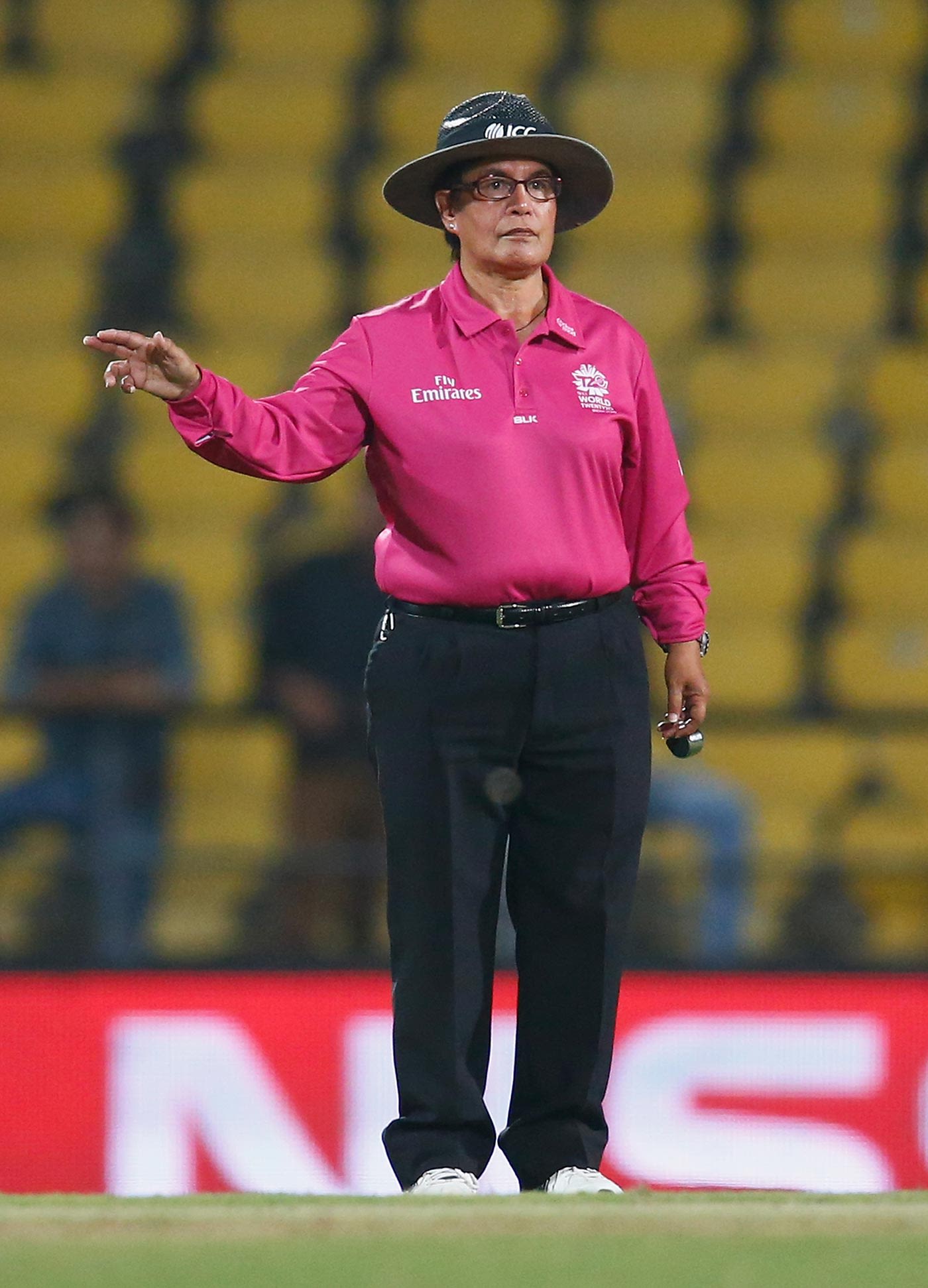 Umpire Kathy Cross signals a four