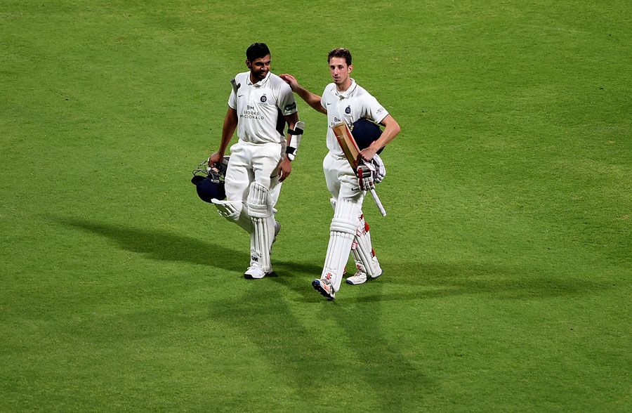 Ravi Patel and John Simpson walk off after securing victory