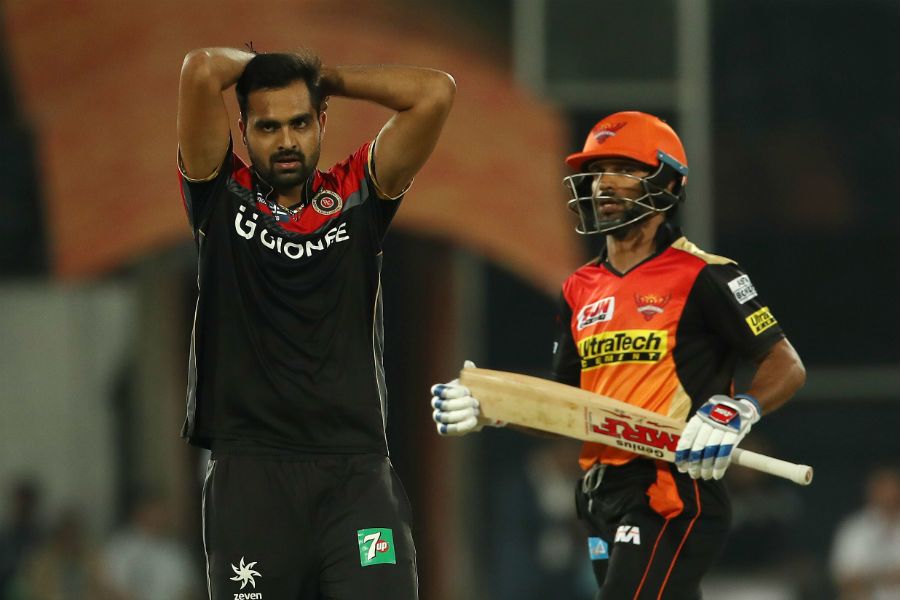 Debutant Aniket Choudhary grimaces as a mistimed hit lands between mid-on and mid-off