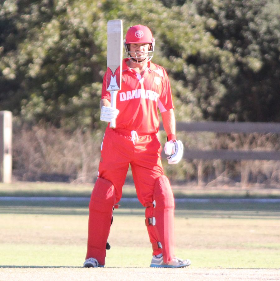 Freddie Klokker raises his bat after another half-century