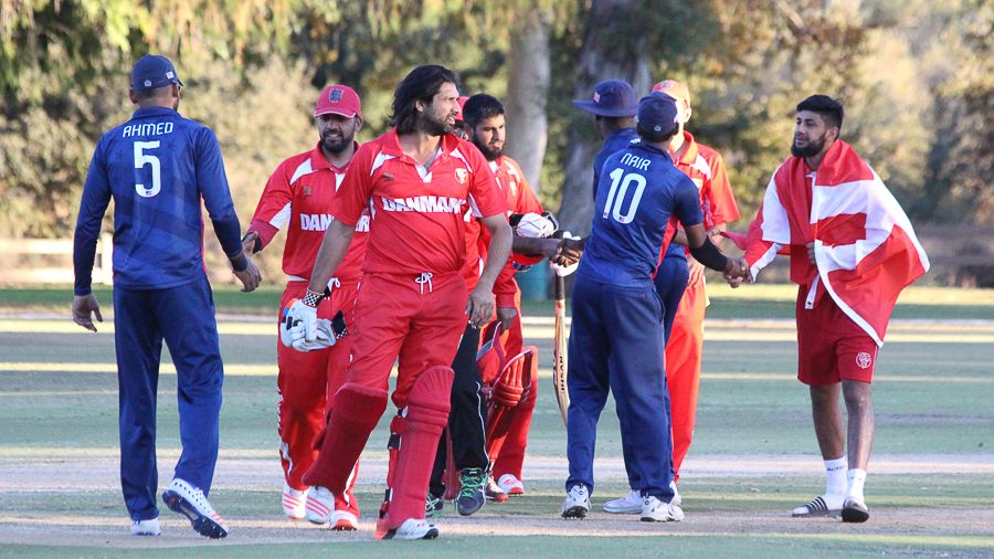 Stand-in captain Amjad Khan leads the handshakes for Denmark after the win