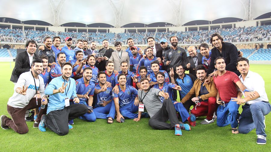 Afghanistan poses for a team photo with the tournament championship trophy
