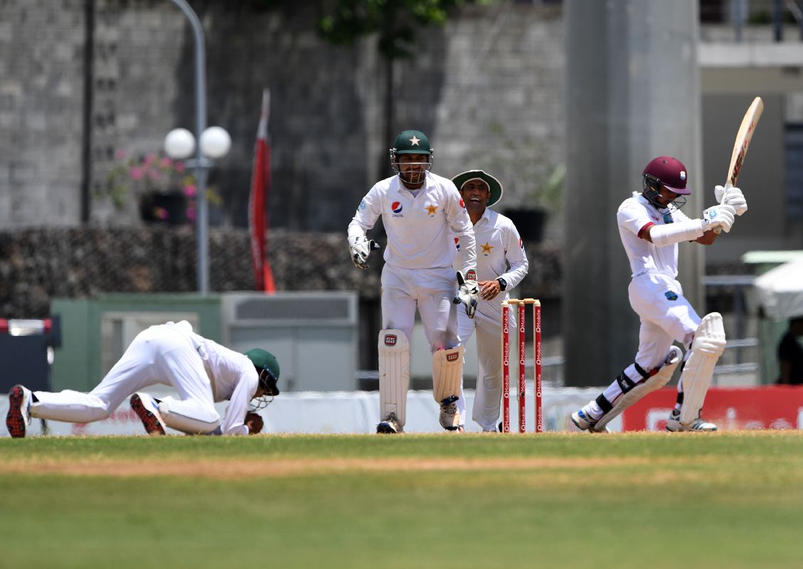Babar Azam dives forward at short leg to catch Vishaul Singh off bat and pad