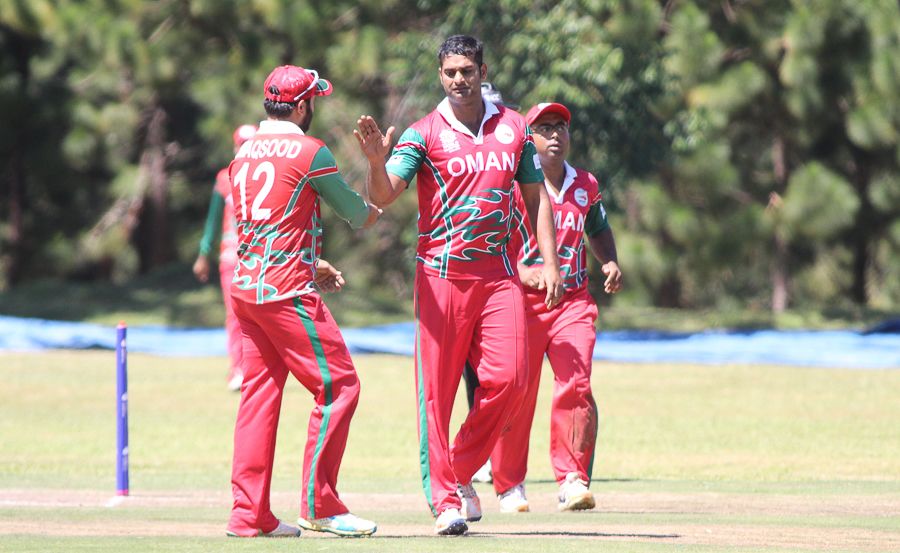 Khawar Ali gets high-fived after taking the wicket of Ibrahim Khaleel