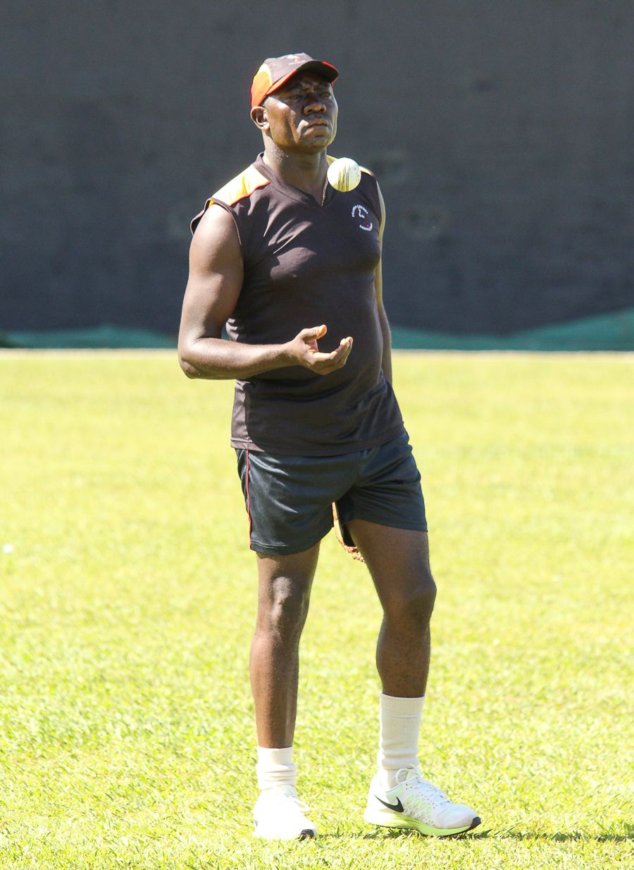 Uganda coach Steve Tikolo observes his players during a training session