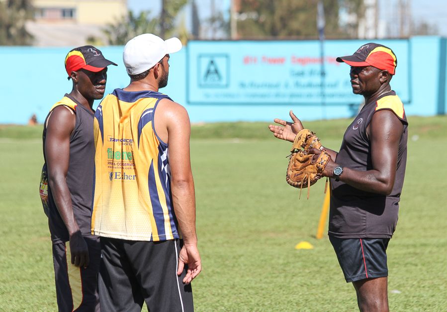 Uganda coach Steve Tikolo talks to Frank Nsubuga and Mohammed Irfan during a training session