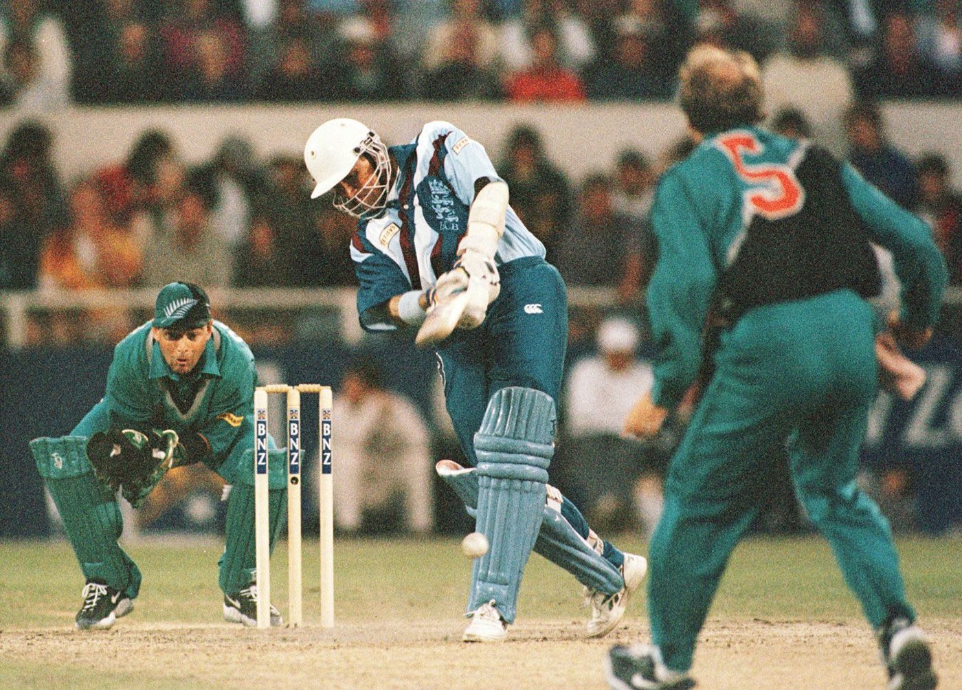 Keeper Lee Germon stands up to the stumps while Chris Harris bowls to Alec Stewart