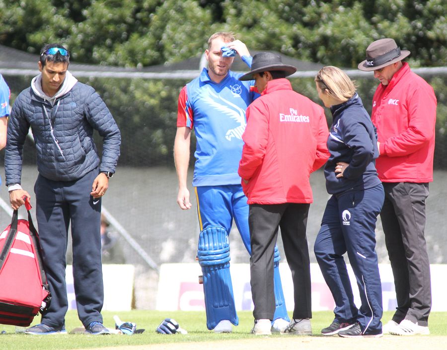 Christi Viljoen gets an ice pack after being hit in the helmet with a Chris Sole bouncer