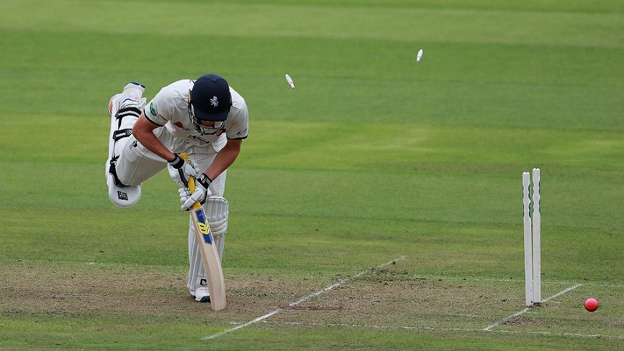 Will Gidman is bowled by Harry Gurney