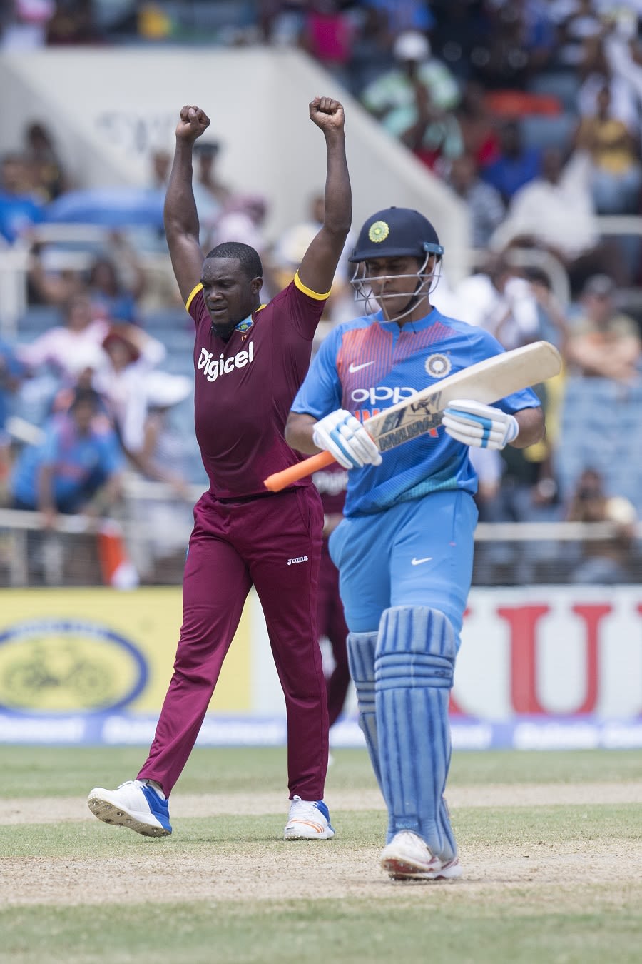 Jerome Taylor celebrates the wicket of MS Dhoni