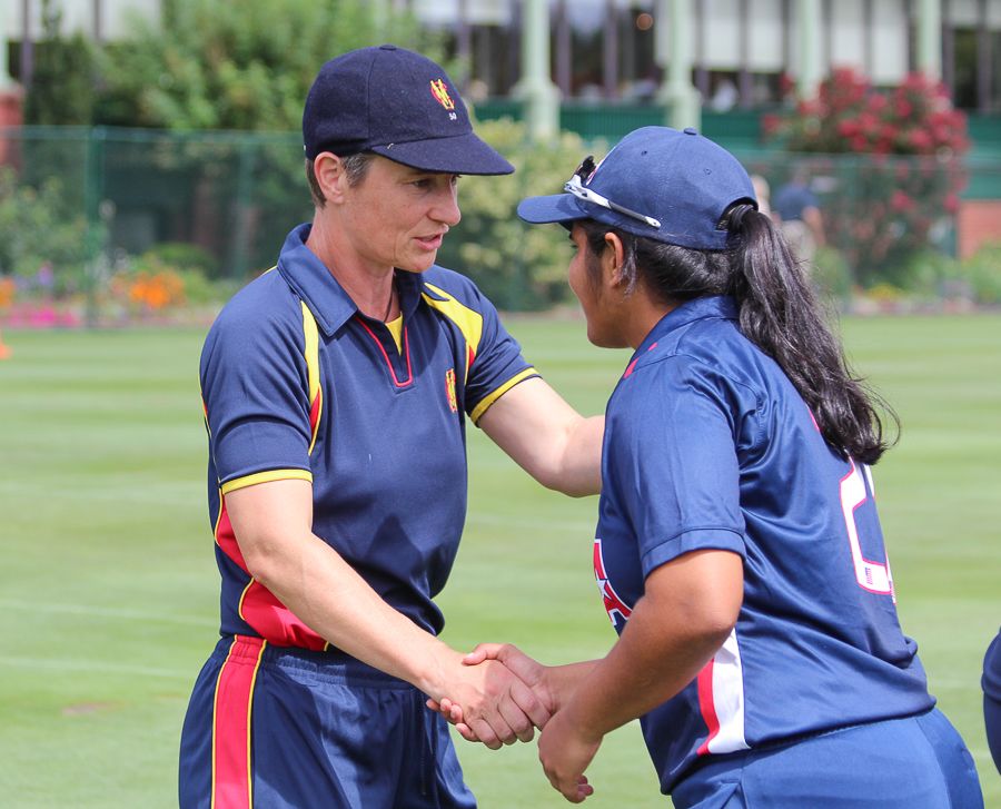 Claire Taylor shakes hands with USA's Shebani Bhaskar