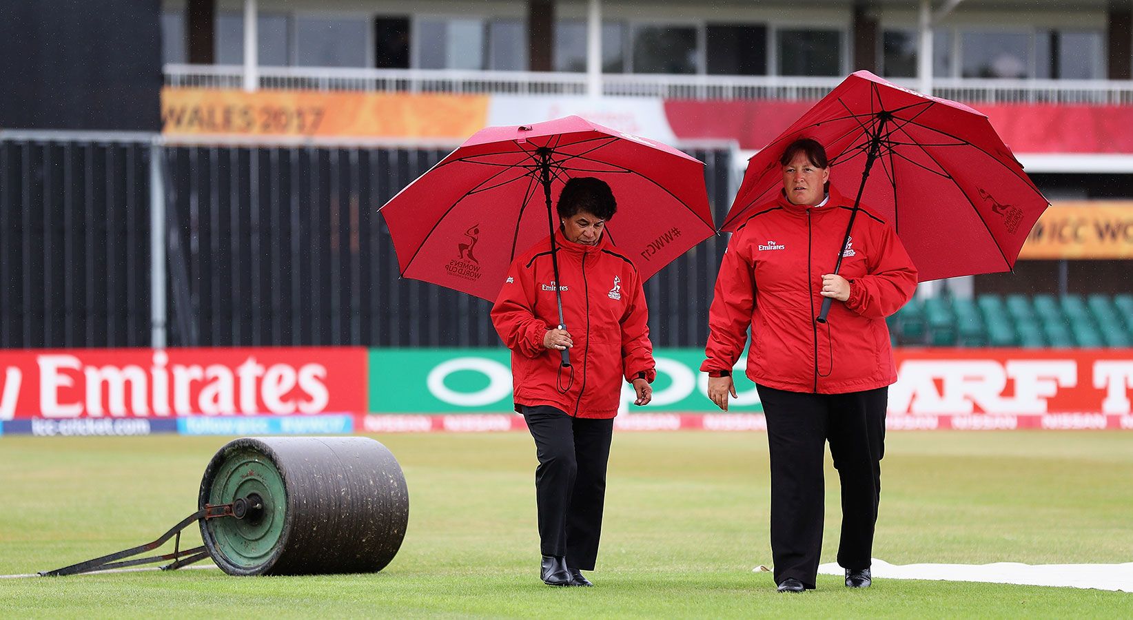 Umpires Kathy Cross and Sue Redfern inspect the outfield