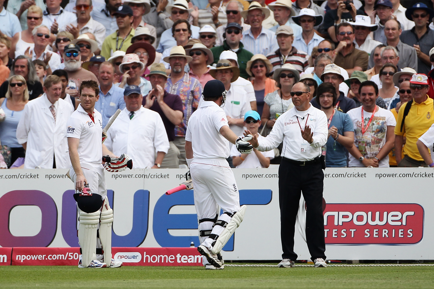 Umpire Tim Robinson tells Ian Bell and Eoin Morgan not to walk out of the field