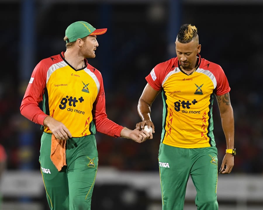Martin Guptill and Rayad Emrit share a moment in the middle