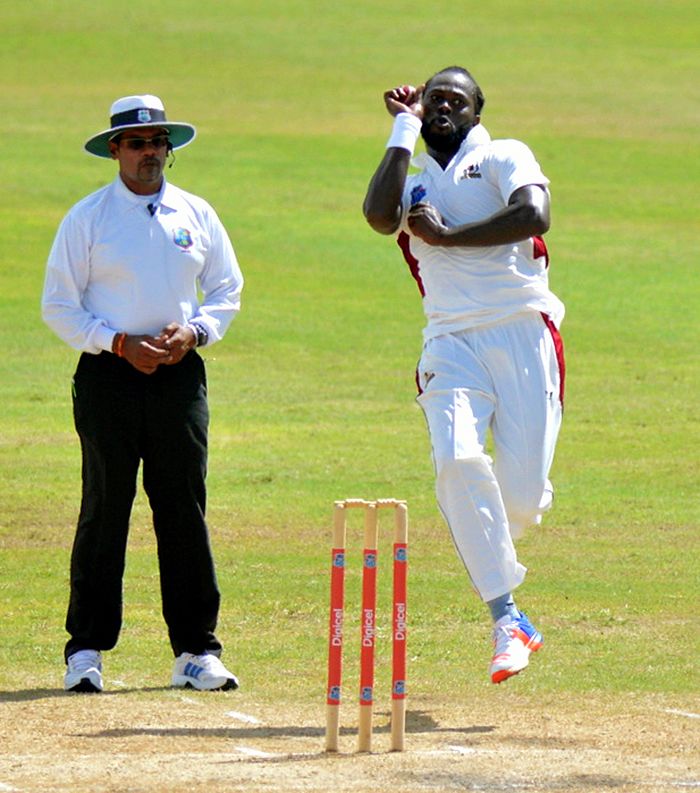 Gavin Tonge, observed by umpire Danesh Ramdhanie here, took nine wickets in the game