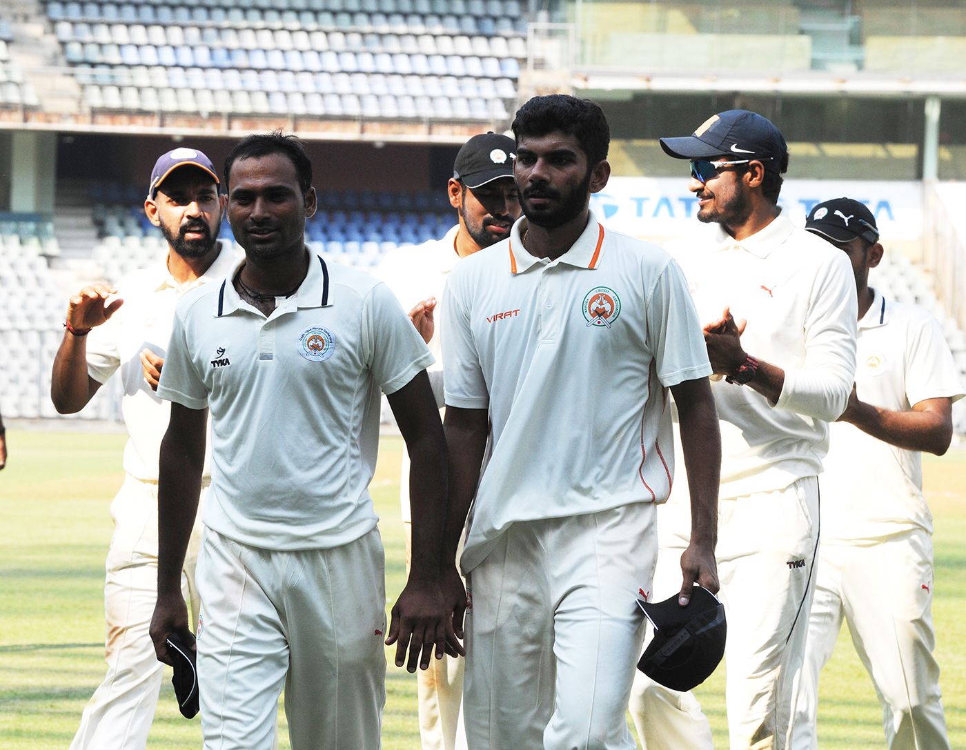 Lukman Meriwala (left) and Atit Sheth are applauded off the field after their five-fors