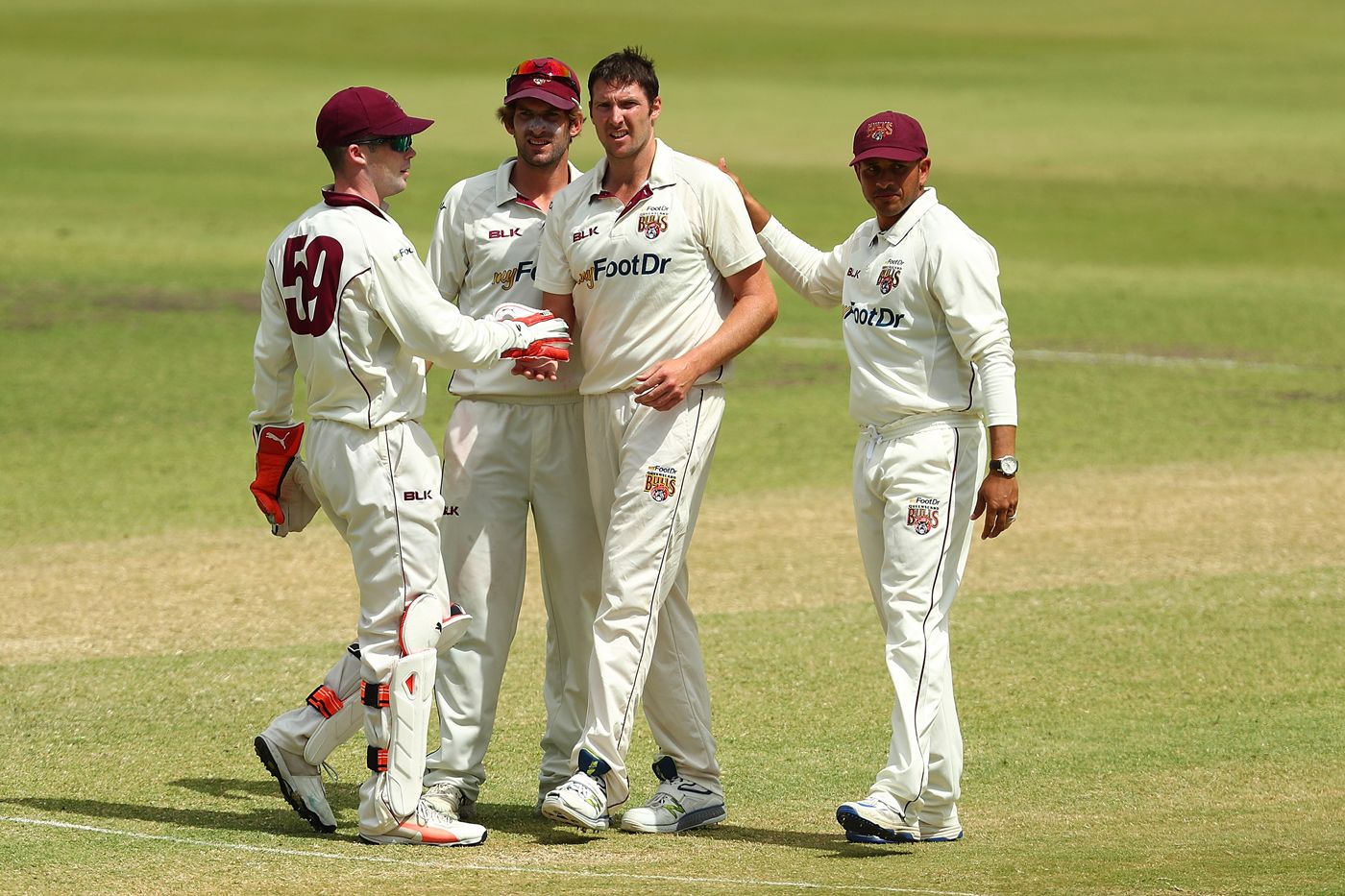 Luke Feldman celebrates the wicket of David Warner