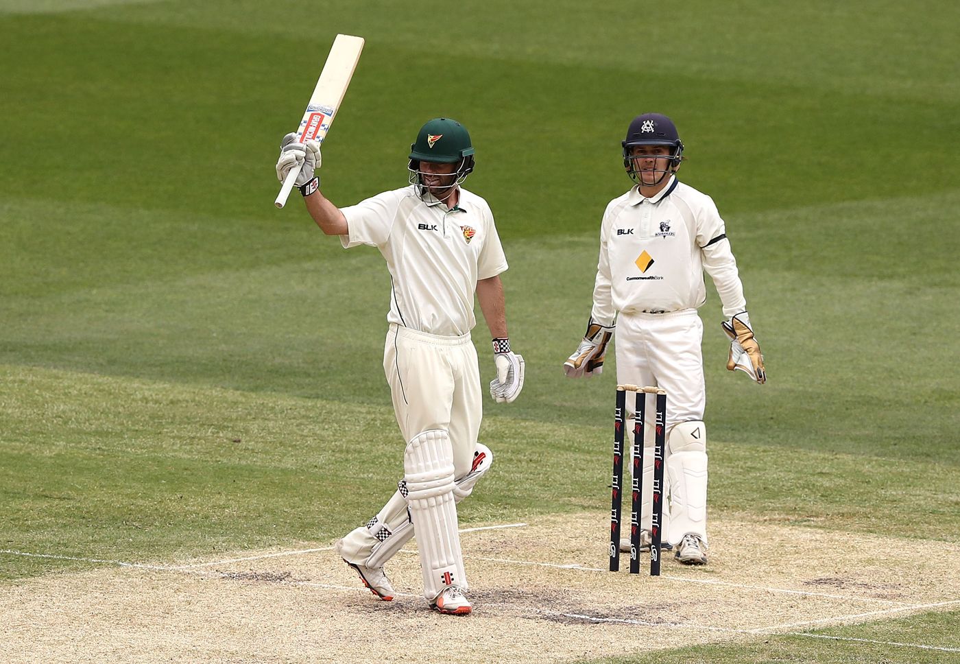 Alex Doolan raises his bat after notching up his double-hundred