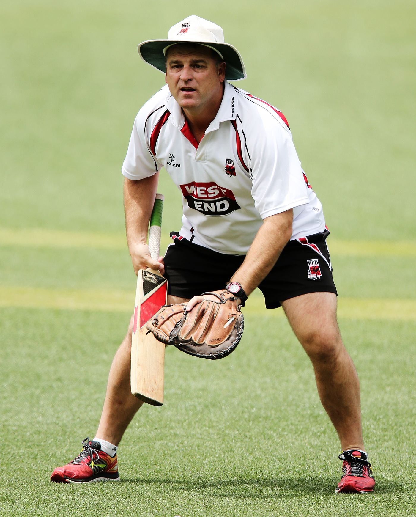 Darren Berry warms up his players before the start of play