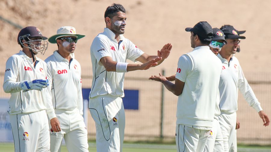 Ahmed Raza gets a high five after dismissing Mohammad Nabi as part of his five-wicket haul