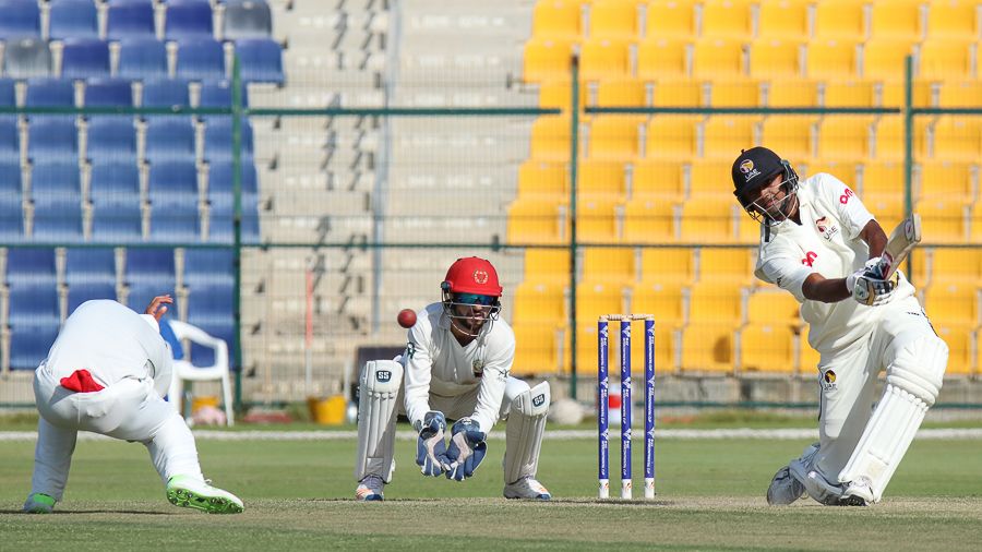 Nasir Jamal takes evasive action as Amjad Javed drives a boundary over cover