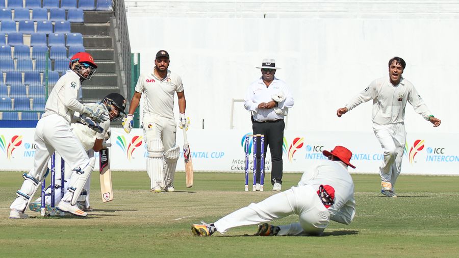 Mohammad Nabi holds on to a catch at slip to give Rashid Khan his third wicket on the way to his fourth five-wicket haul
