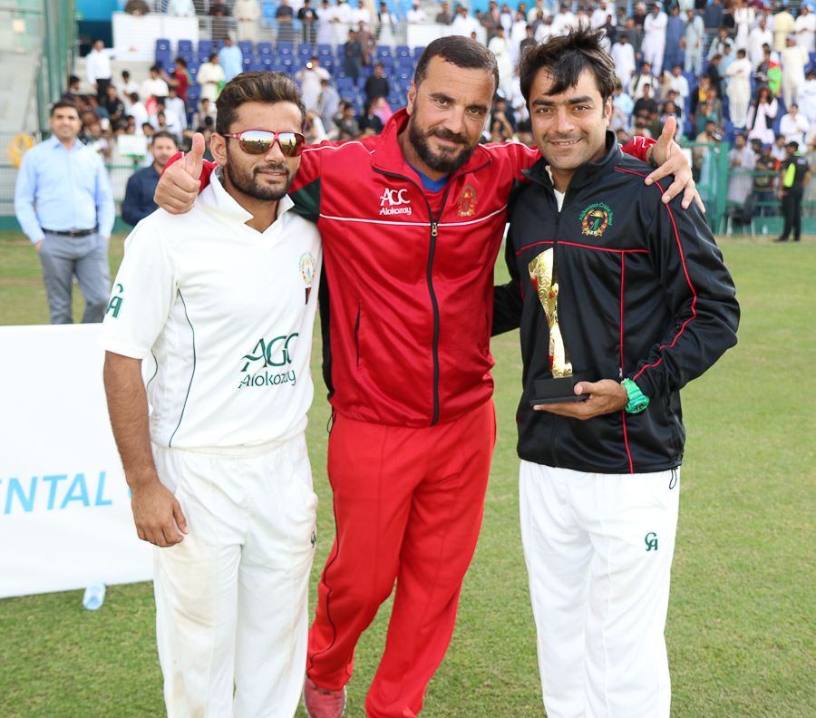 Zahir Khan, coach Raees Ahmadzai and Rashid Khan celebrate winning the Intercontinental Cup