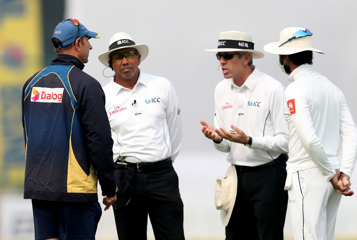 Sri Lanka coach Nic Pothas and captain Dinesh Chandimal have a chat with the umpires as bad weather stops play