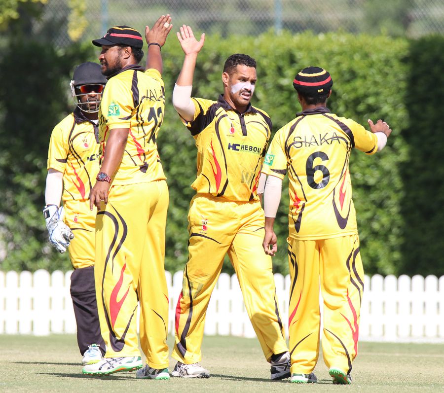 Chad Soper gets a high five from captain Assad Vala and Lega Siaka after taking a wicket