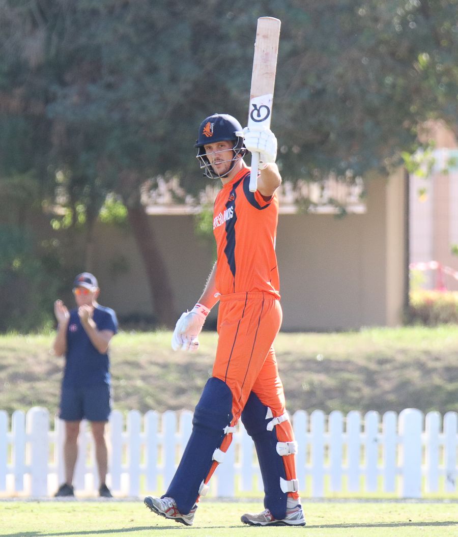 Ben Cooper raises his bat for a half-century