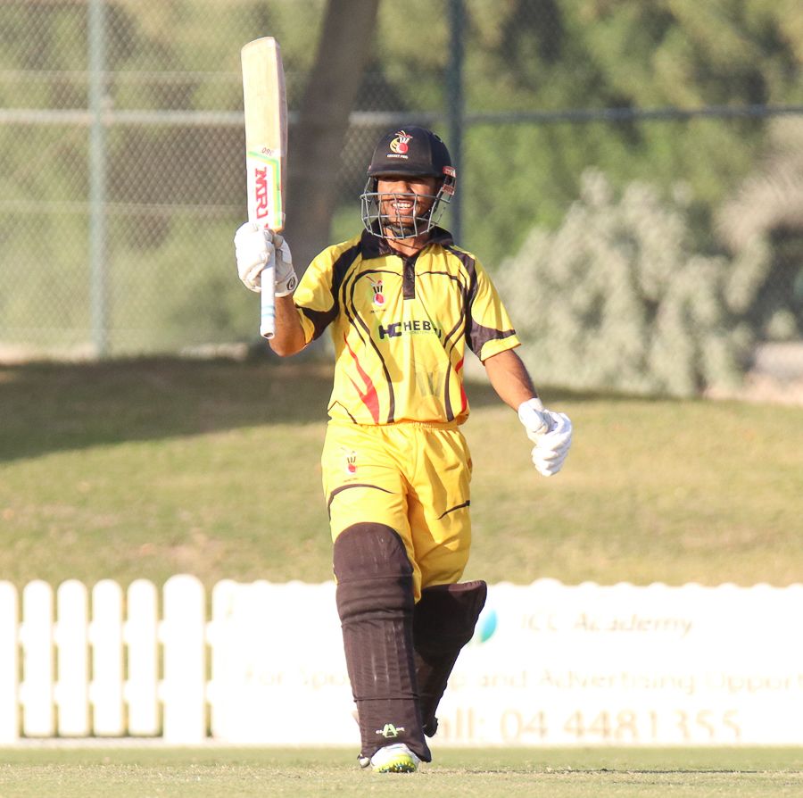 Sese Bau grins and raises his bat after reaching his maiden ODI fifty